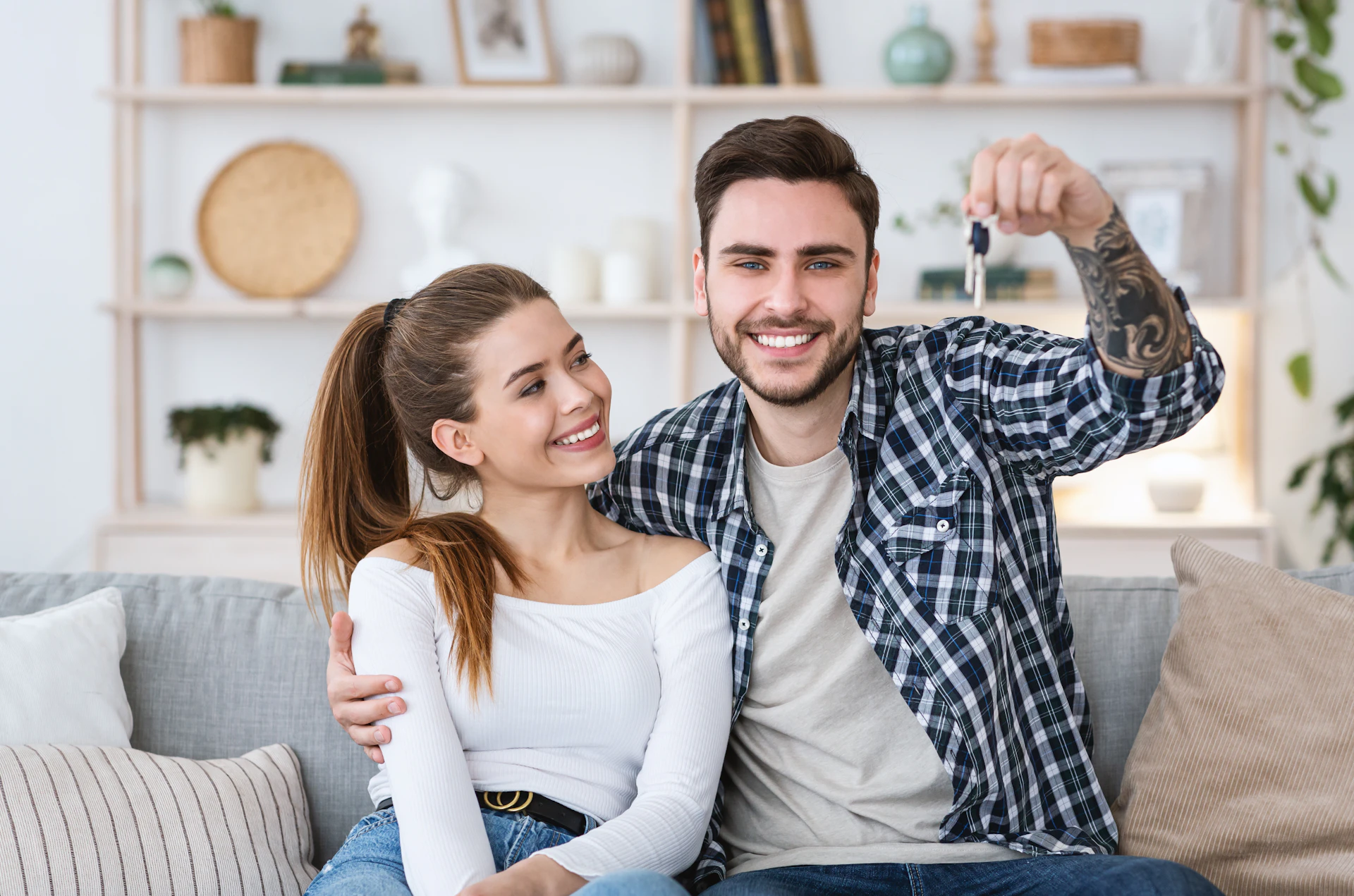 Couple of landlords relaxing and smiling while checking their property online